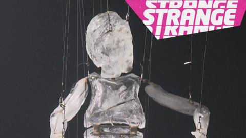 An ice puppet and the Strange logo