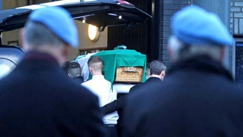 The coffin of Private Sean Rooney is carried into Holy Family Church, Dundalk, Co Louth
