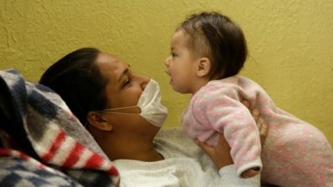 A migrant from Brazil, sent back to Mexico from the United States under an Asylum Cooperative Agreement (ACA), plays with her daughter at the El Buen Pastor shelter, in Ciudad Juarez