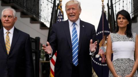 President Donald Trump, flanked by Secretary of State Rex Tillerson (L) and US Ambassador to the United Nations Nikki Haley (R), at his golf estate in Bedminster, New Jersey