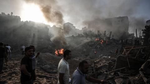 Civil defence teams and civilians try to rescue people under the rubbles after Israeli attacks destroyed buildings as the Israeli airstrikes and artillery fires continue on the 19th day in Gaza City, Gaza on October 25, 2023.