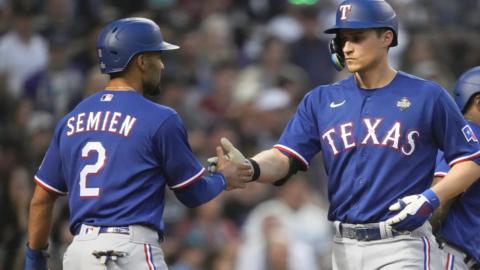 Texas Rangers' Marcus Semien and Corey Seager celebrate Seager's home run