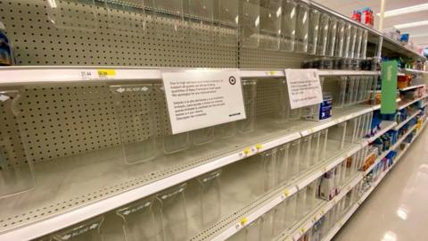 Image shows empty shelves during the shortage