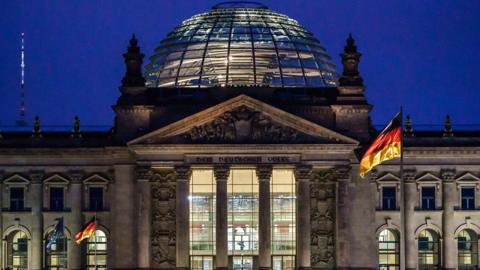 The Reichstag building at night. It houses the Bundestag - lower house of the federal parliament.