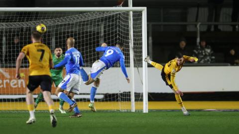 Notts County striker Macaulay Langstaff scores a goal with a header