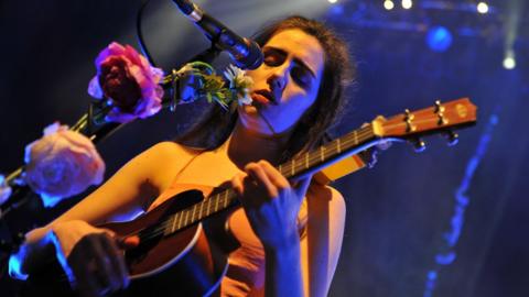 Dodie performing on stage