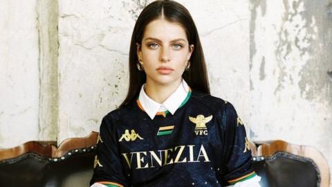 Promotional photograph showing a woman modelling one of Venezia's 2021/22 shirts