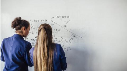 girls working on maths board