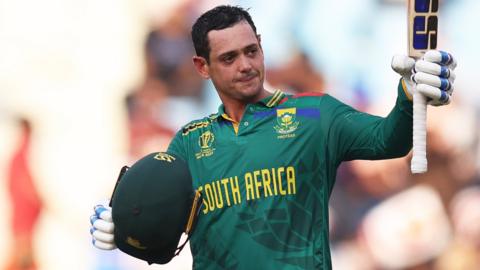 South Africa's Quinton de Kock raises his bat to celebrate scoring a century against Australia