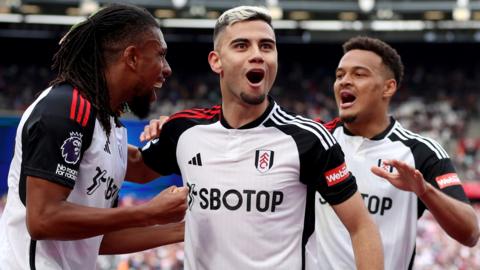Andreas Pereira of Fulham celebrates scoring his team's second goal with Alex Iwobi and Rodrigo Muniz of Fulham