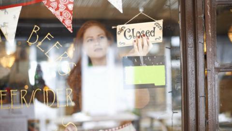 A woman closing her cafe