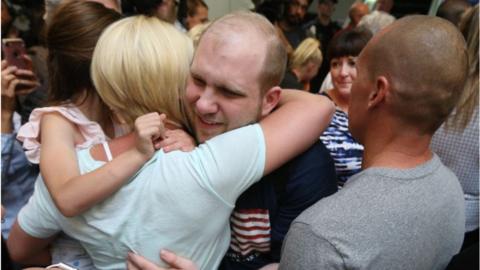 Josh Holt hugs family