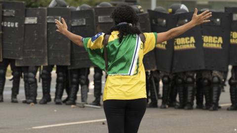 Woman protester facing police