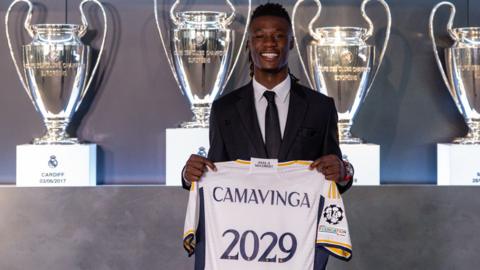 Eduardo Camavinga holds a Real Madrid shirt after signing a new deal