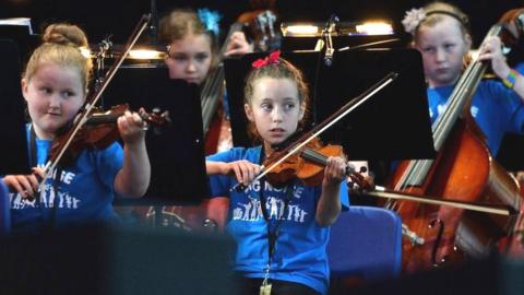 Children from the Raploch estate Big Noise orchestra play at The Big Concert on 21 June 2012 in Stirling, Scotland