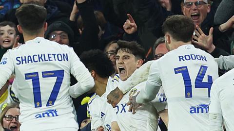 Daniel James being mobbed by Leeds teammates after scoring