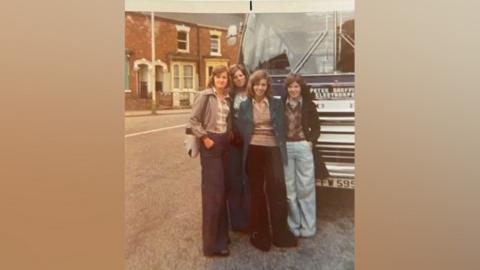 Christine Walker (left), Sue Pinyoun, Elaine Smith and Helen Steel standing in front of the coach outside Cleethorpes Town Hall before the 1975 trip to Königswinter