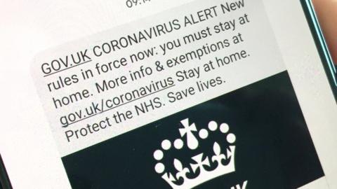 Text message on a smartphone that says Coronavirus Alert