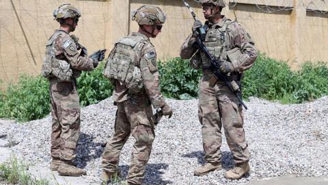 Soldiers from the US-led coalition forces are seen during the handover of the K1 Air Base to the Iraqi Army from the US-led coalition in Kirkuk, Iraq in 2020