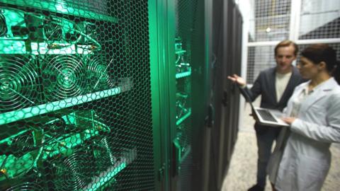 Staff in a crypto-currency mining facility