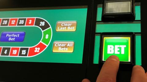 A man gambles on a fixed odds betting terminal in Manchester