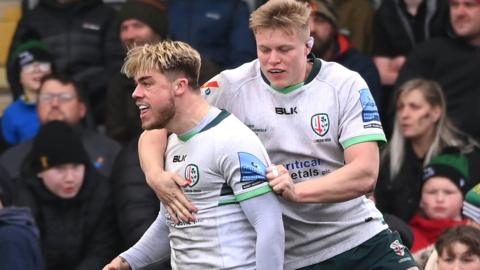 Ollie Hassell-Collins celebrates scoring a try for London Irish