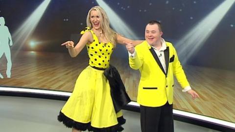 Nathan Morris and his partner Jo Banham wearing yellow outfits while performing