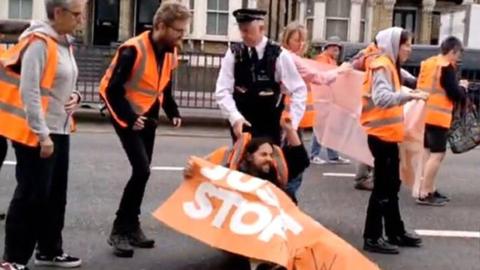 The officer dragged the man by his hi-vis jacket