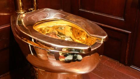 Gold toilet by Maurizio Cattelan