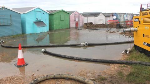 Flooded beach huts in Bulverhythe in August