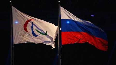 The Paralympic flag flies next to the Russia flag during the Opening Ceremony of the Sochi 2014 Paralympic Winter Games