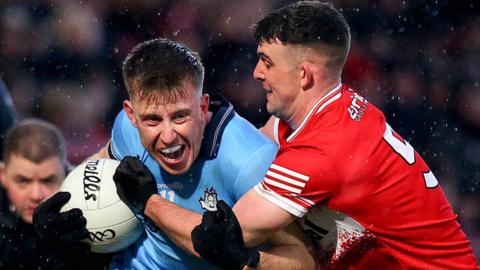 Dublin's Seán Bugler is challenged by Shay Downey and