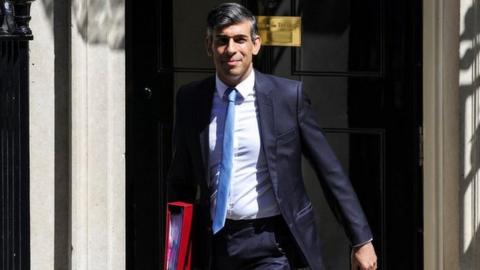 Sunak pictured walking out of No 10