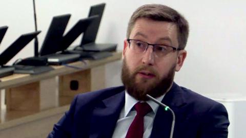 Simon Case headshot wearing glasses and suit and tie while giving evidence at the Covid Inquiry on 23 May