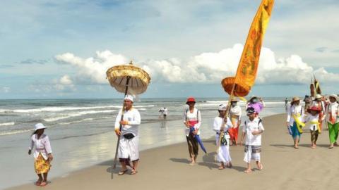 Balinese Hindus go to the beach before the Day of Silence for a purification ceremony known as Melasti.