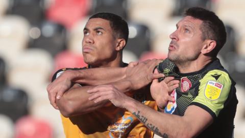 Priestley Farquharson of Newport County and Joe Martin of Stevenage in action