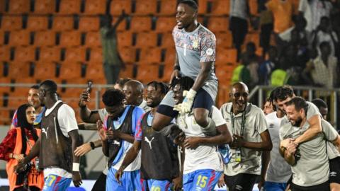 Lionel Mpasi is carried off by DR Congo team-mates after their penalty shoot-out win against Egypt