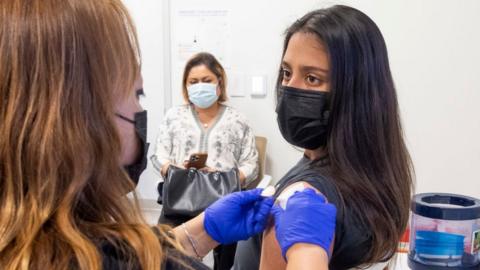 16-year-old getting a jab