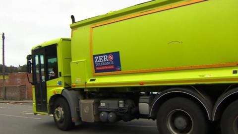A big green Cityclean bin lorry