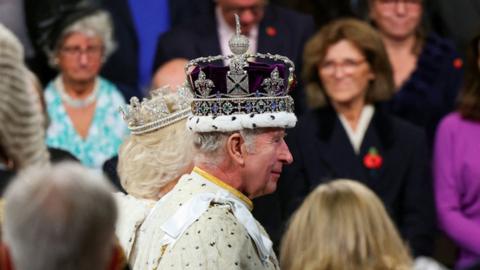 Britain's King Charles walks with Queen Camilla after delivering a speech at the State Opening of Parliament at the Houses of Parliament in London, Britain, November 7, 2023.