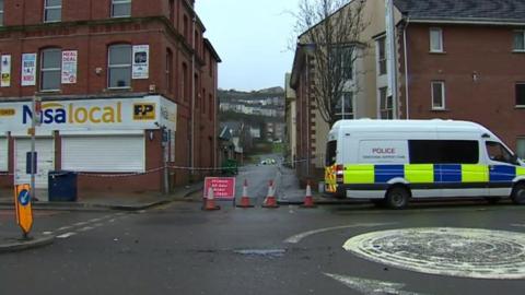 a police van at High Street, Swansea, where a road has been cordoned off following an incident