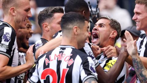 Newcastle players celebrate together against Aston Villa