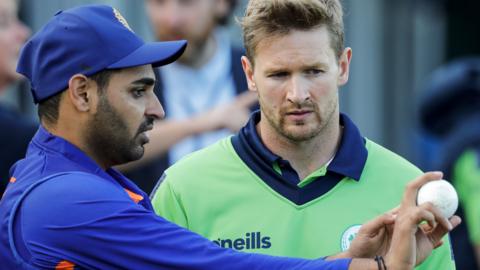 India's Bhuvneshwar Kumar gives bowling tips to Ireland paceman Barry McCarthy during last year's series at Malahide