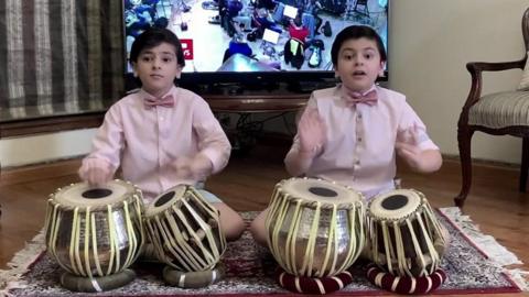 Two drum playing brothers