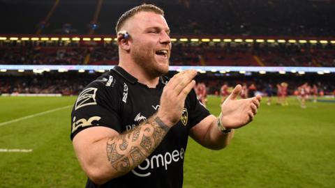 Lloyd Fairbrother applauds fans during a Dragons match