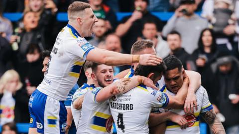 Warrington players flood in to pile on try-scorer Peter Mata'utia