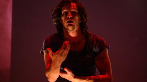 An actor uses sign language expressively