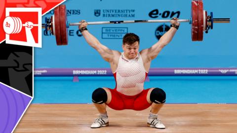 A weightlifter competes