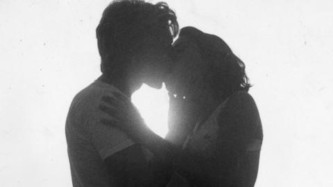 Couple kissing in silhouette