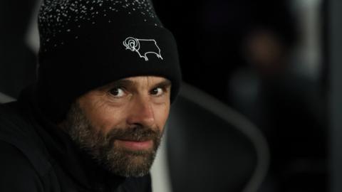 Derby County manager Paul Warne looks out from the dugout